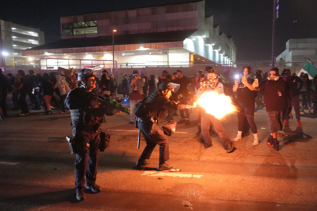 Los Angeles police fire less lethal rounds at protesters in downtown Los Angeles on Friday, Jan. 30, 2026. (AP Photo/Jae C. Hong)