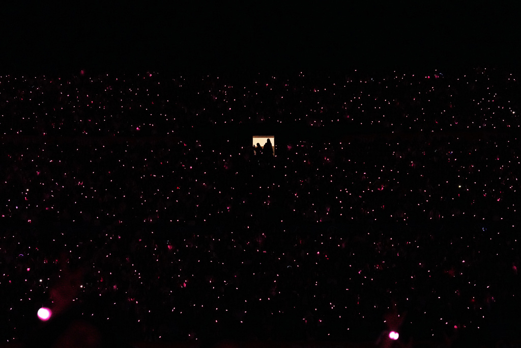 FILE - Fans of Colombian singer Shakira attend her concert in Montevideo, Uruguay, Dec. 3, 2025. (AP Photo/Matilde Campodonico, File)