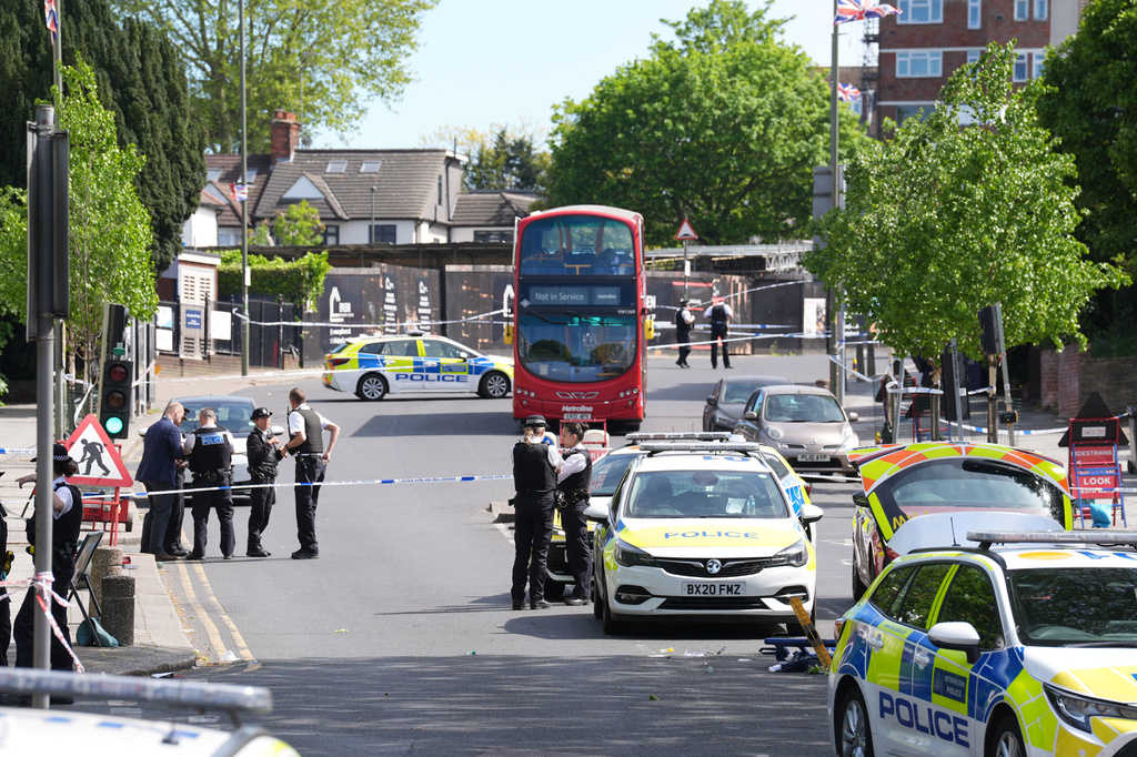 Police at the scene where two people were stabbed Wednesday April 29, 2026 in a London neighborhood with a large Jewish community and a 45-year-old man was arrested on suspicion of attempted murder over what authorities called an antisemitic attack. (Lucy North/PA via AP)