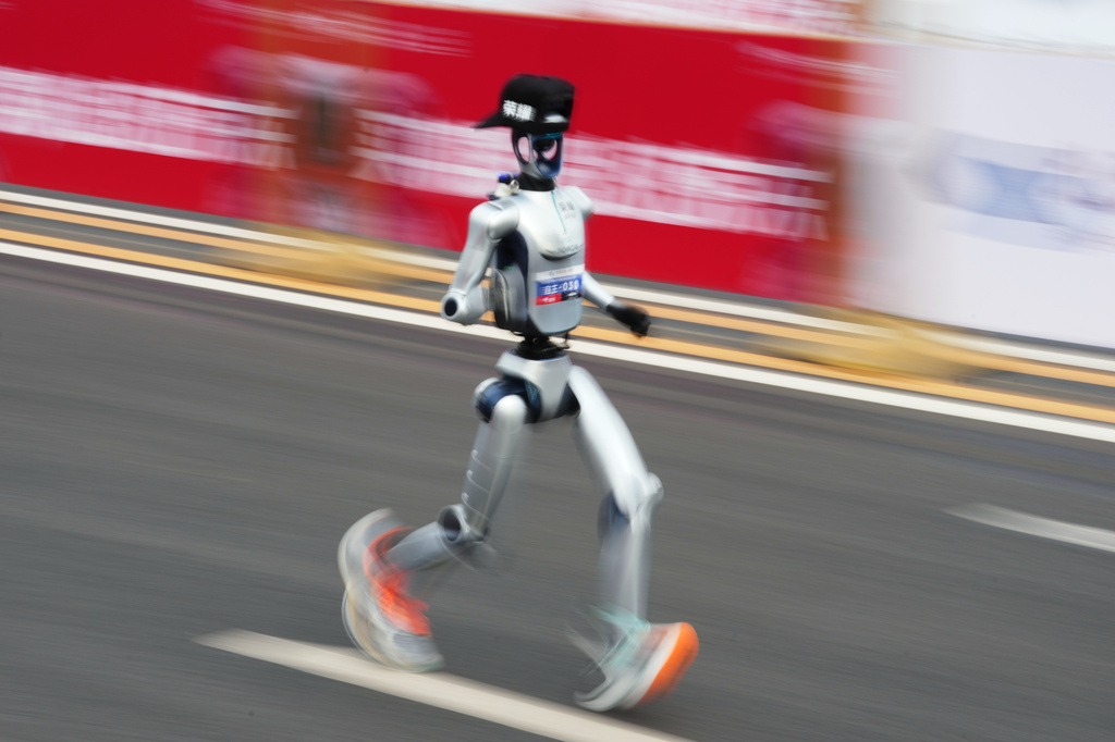 A robot starts off for the Beijing E-Town Half Marathon and Humanoid Half Marathon on the outskirts of Beijing on Sunday, April 19, 2026. (AP Photo/Ng Han Guan)