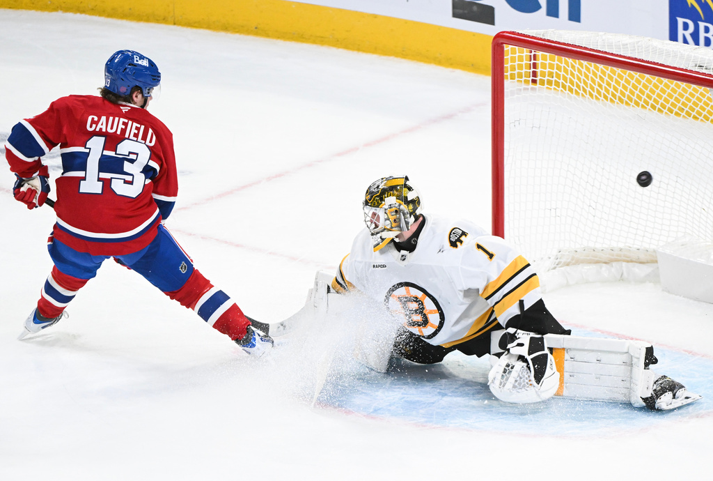 Montreal Canadiens' Cole Caufield (13) scores against Boston Bruins goaltender Jeremy Swayman during second period NHL hockey action in Montreal, Saturday, Nov. 15, 2025. (Graham Hughes/The Canadian Press via AP)