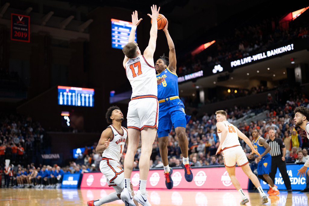Pittsburgh guard Omari Witherspoon (8) stopped by Virginia center Johann Gruenloh (17) during the first half of an NCAA college basketball game, Tuesday, Feb. 3, 2026, in Charlottesville, Va. (AP Photo/Robert Simmons)