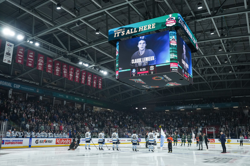 Players and spectators stand for a moment of silence for the late Claude Lemieux before the Everett Silvertips and Chicoutimi Sagueneens play the Memorial Cup semifinal hockey game in Kelowna, British Columbia, Friday, May 29, 2026. (Darryl Dyck/The Canadian Press via AP)