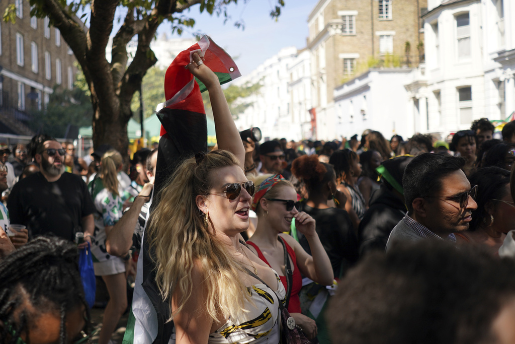 People sing and dance to celebrate Notting Hill Carnival in London, Monday, Aug. 25, 2025, Europe's biggest street party and one of the largest carnivals in the world.(AP Photo/Alberto Pezzali)