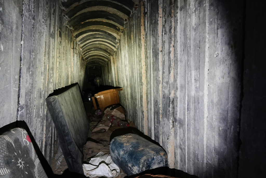 Mattresses and a plastic chair lie on the floor inside a tunnel in Rafah, Gaza Strip, Monday, Dec. 8, 2025. (AP Photo/Sam Mednick)