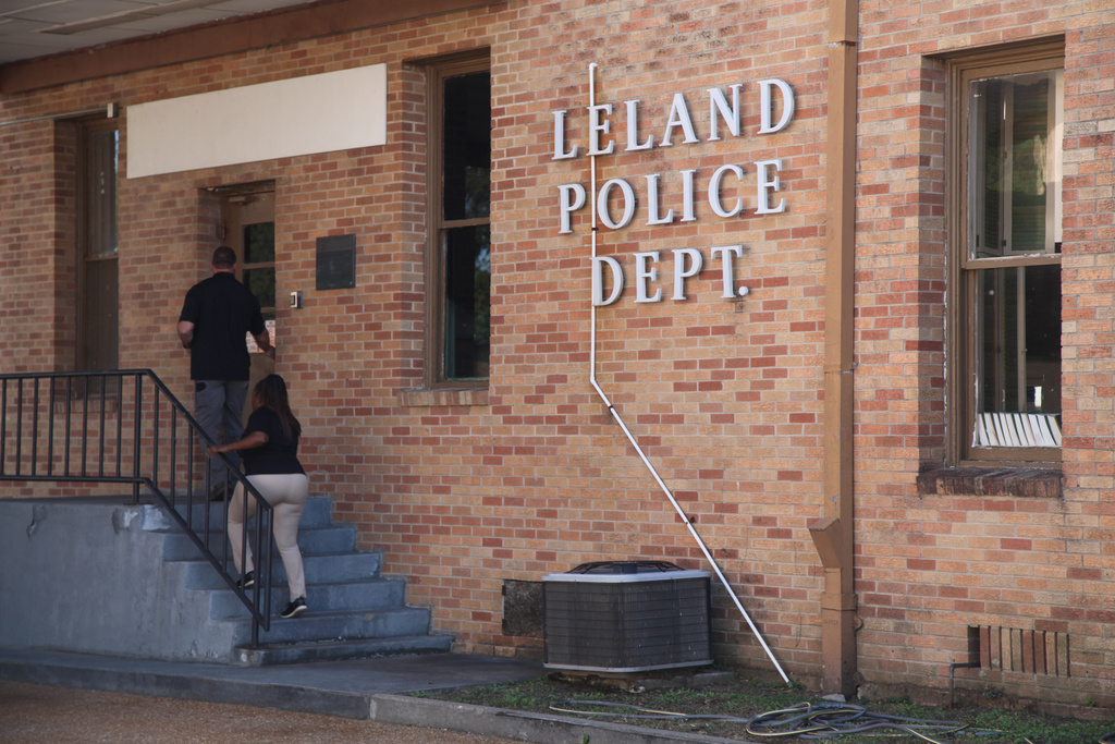 Members of the Leland Police Department enter the police station in Leland, Miss., Saturday, Oct. 11, 2025, after a homecoming shooting. (AP Photo/Katie Adkins)