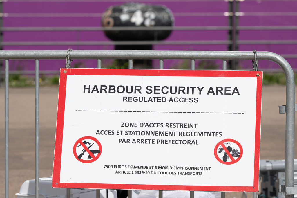 A barrier is set in front of the British cruise ship Ambition, as French authorities have ordered 1,700 passengers and crew to stay on board due to a gastrointestinal illness outbreak, in Bordeaux, southwestern France, Wednesday, May 13, 2026. (AP Photo/Caroline Blumberg)