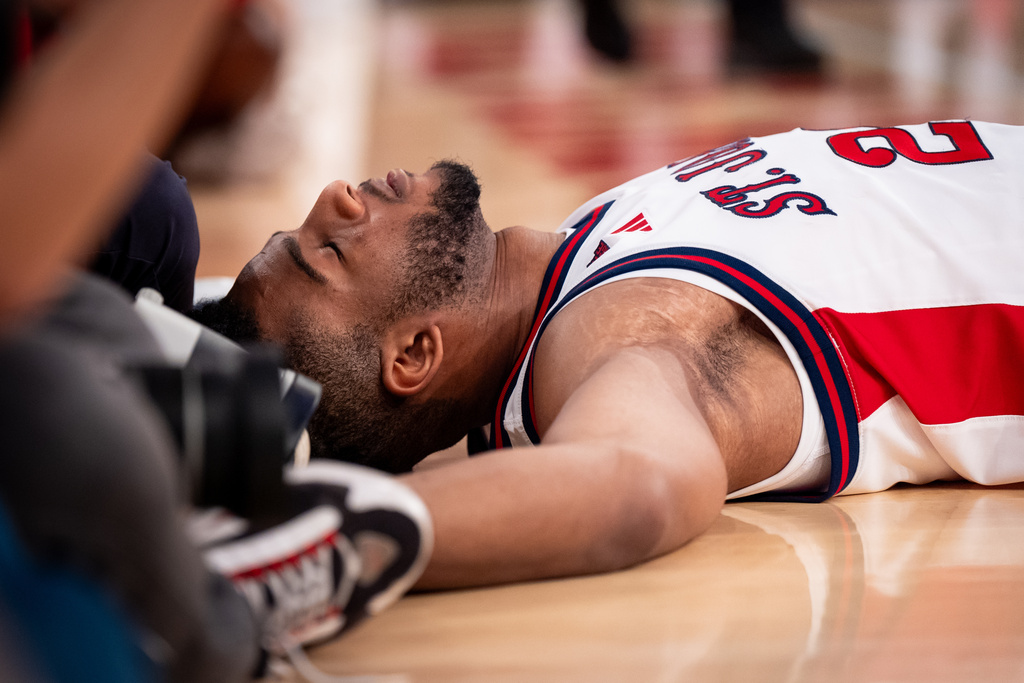 St. John's forward Zuby Ejiofor (24) lays on the court after a fall during the second half of an NCAA college basketball game against Alabama, Saturday, Nov. 8, 2025, in New York. (AP Photo/Angelina Katsanis)