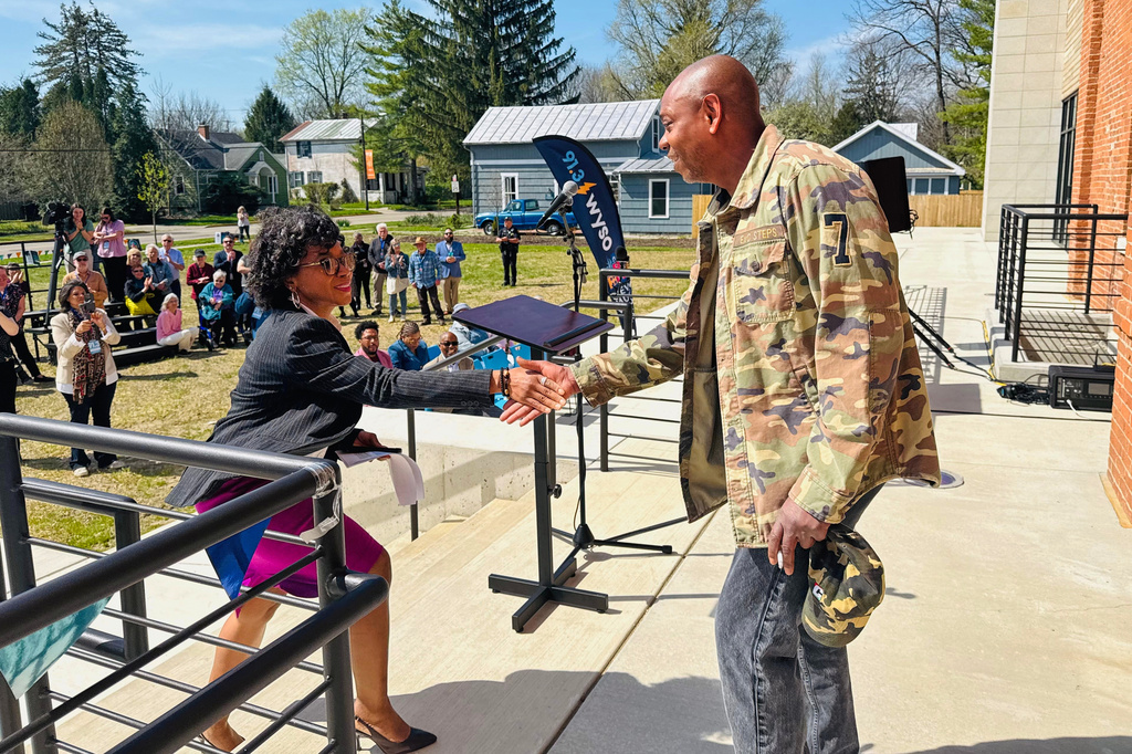 Comedian Dave Chappelle, right, shakes hands with Dayton Mayor Shenise Turner-Sloss at a ribbon-cutting ceremony for a new studio for WYSO Public Radio in Yellow Springs, Ohio, on April 9, 2026. (AP Photo/Jonathan Landrum)