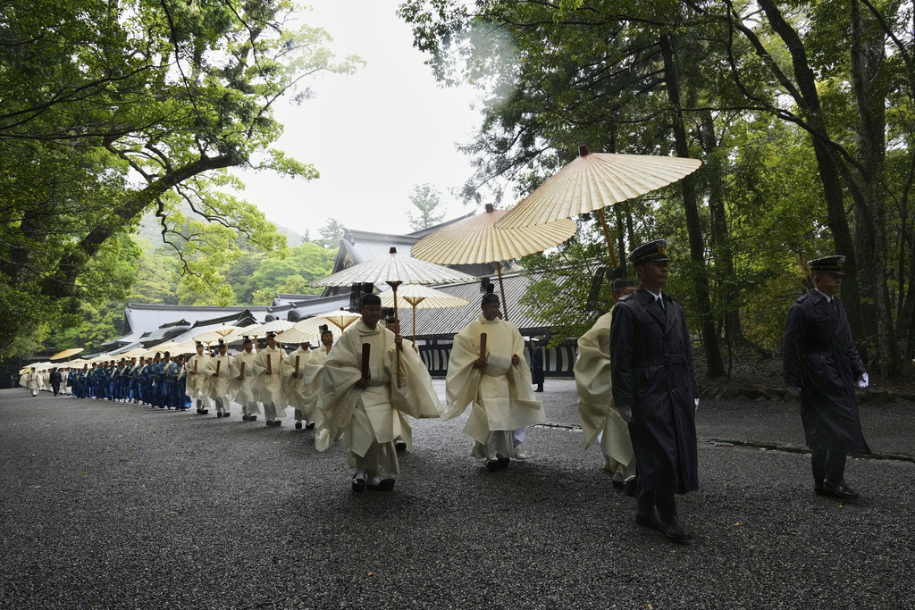 Priests and officials in the Shinto priesthood march during Yamaguchisai, a kickoff ceremony of the Shikinen Sengu ritual, which concludes in 2033, at Kotaijingu, also known as Naiku, or the inner sanctuary, of the Jingu shrine complex in Ise, central Japan, Friday, May 2, 2025. (AP Photo/Hiro Komae)