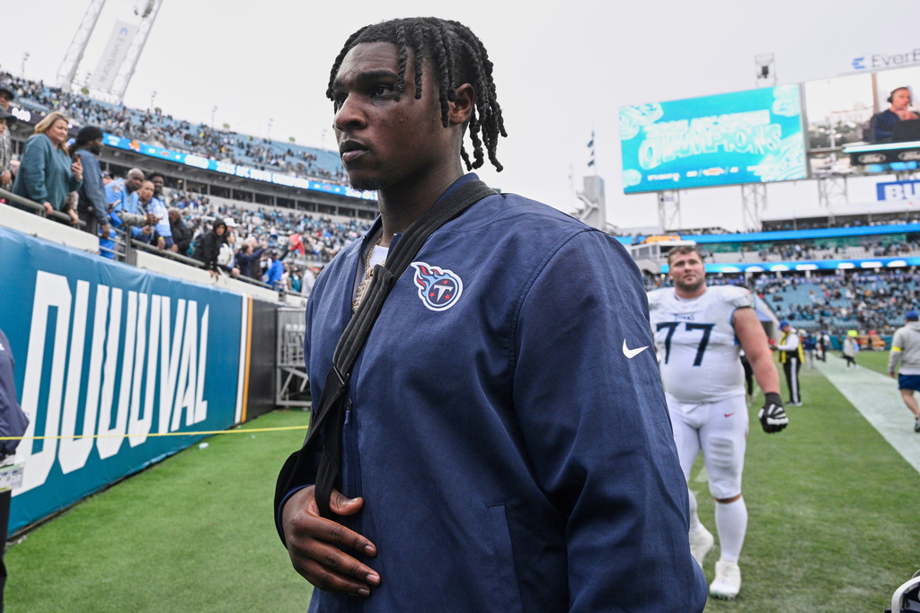 Tennessee Titans quarterback Cam Ward leaves the field after the team's loss in an NFL football game against the Jacksonville Jaguars, Sunday, Jan. 4, 2026, in Jacksonville, Fla. (AP Photo/Phelan M. Ebenhack)