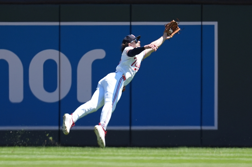 Minnesota Twins center fielder James Outman (30) catches a line out hit by Houston Astros' Christian Walker (8) during the third inning of a baseball game Wednesday, May 20, 2026, in Minneapolis. (AP Photo/Abbie Parr)