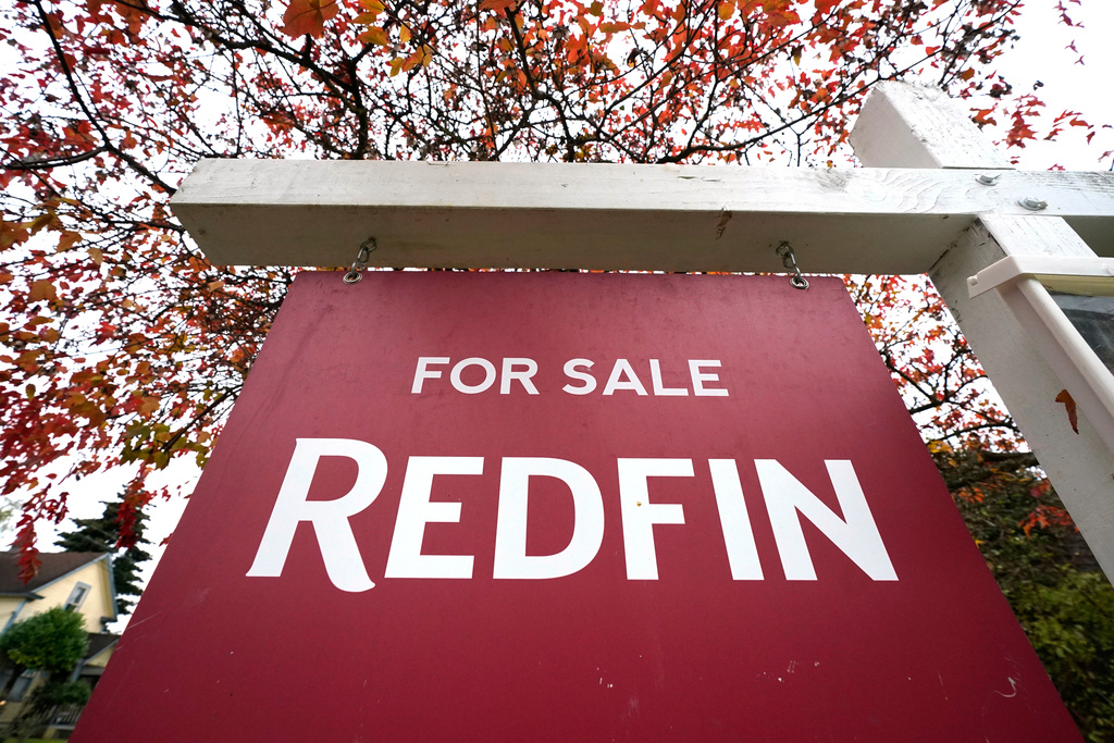 FILE - A Redfin "for sale" sign stands in front of a house on Oct. 28, 2020, in Seattle. (AP Photo/Elaine Thompson, File)