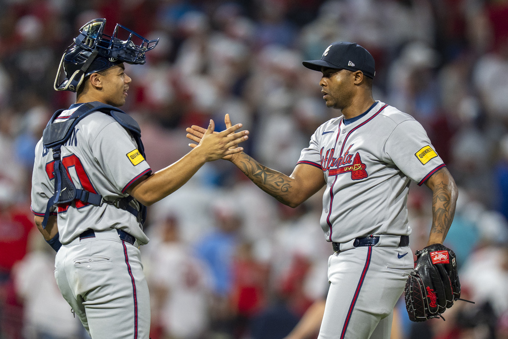 Atlanta Braves relief pitcher Raisel Iglesias, right, celebrates with catcher Drake Baldwin, left, after a baseball game against the Philadelphia Phillies, Sunday, Aug. 31, 2025, in Philadelphia. (AP Photo/Chris Szagola)