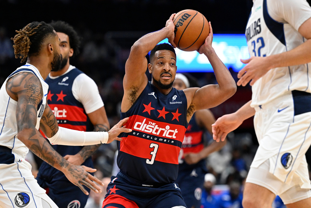 Washington Wizards guard CJ McCollum (3) passes off during the first half of an NBA basketball game against the Dallas Mavericks, Saturday, Nov. 8, 2025, in Washington. (AP Photo/John McDonnell)