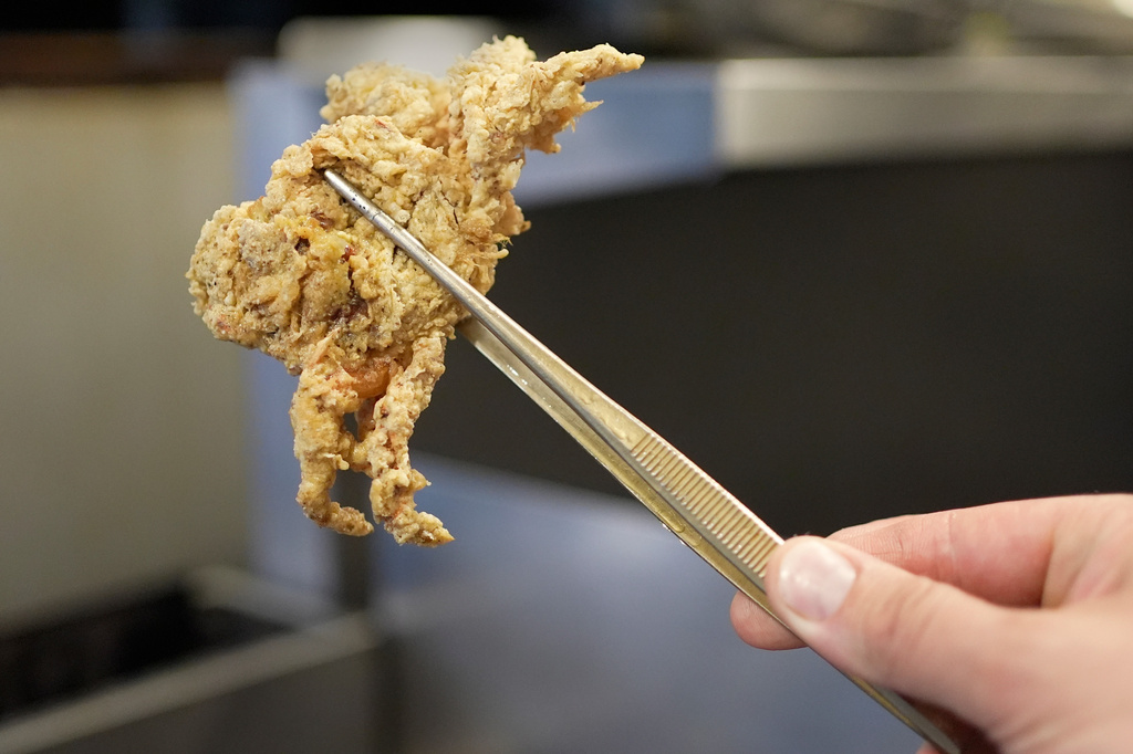 A breaded green crab is pulled from a fryer at Signal restaurant Tuesday, June 16, 2026, in Kennebunk, Maine. (AP Photo/Robert F. Bukaty)