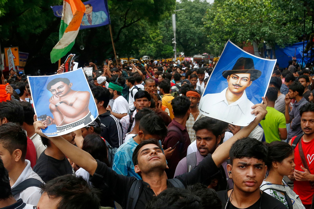 A supporter of the Cockroach Janta Party holds posters of Bhagat Singh, an Indian revolutionary freedom fighter, at Jantar Mantar in New Delhi, Tuesday, July 21, 2026. (AP Photo/Shekhar Yadav)
