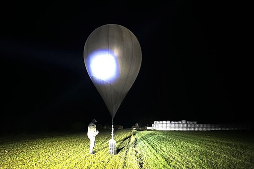In this undated photo released by the State Border Guard Service, an officer inspects a balloon used to carry cigarettes into Lithuania, because Belarussian smugglers often use them to ferry the contraband into the European Union (State Border Guard Service via AP) In this undated photo released by the State Border Guard Service, an officer inspects a balloon used to carry cigarettes into Lithuania, because Belarussian smugglers often use them to ferry the contraband into the European Union (State Border Guard Service via AP)
