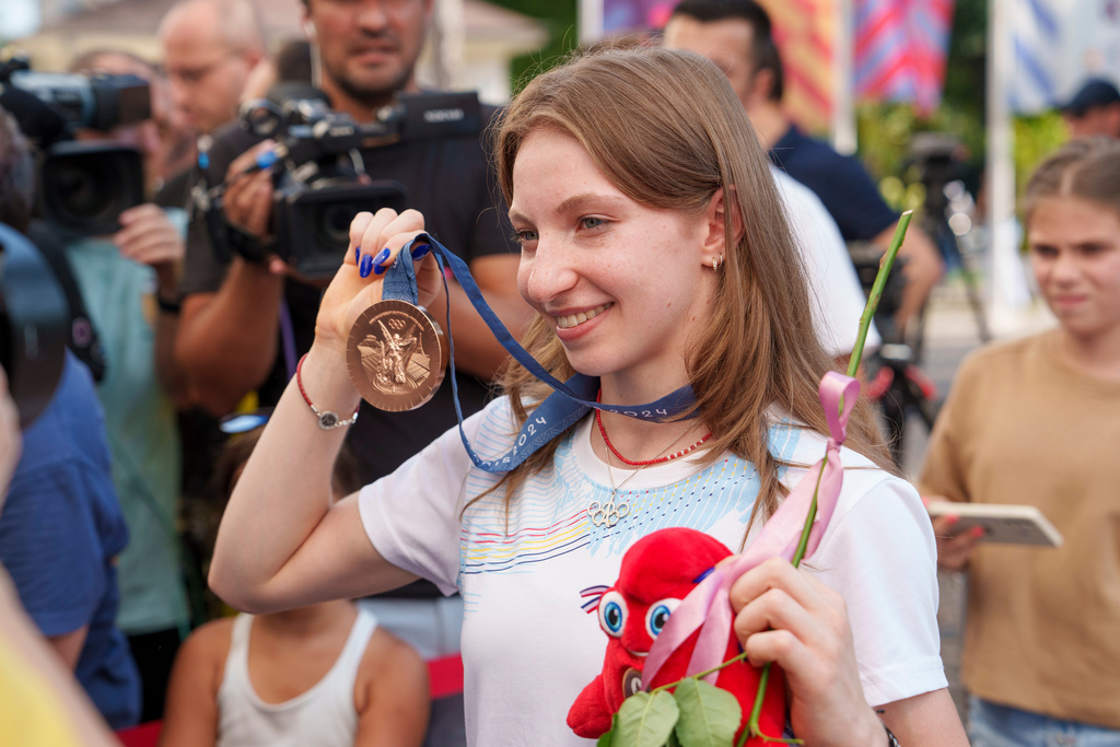 FILE - Romanian gymnast Ana Barbosu poses with the bronze medal for her women's artistic gymnastics individual floor performance at the Paris 2024 Olympics, after receiving it during a ceremony at the Romanian Olympic and Sports Committee, in Bucharest, Romania, Aug. 16, 2024. (AP Photo/Vadim Ghirda, File)