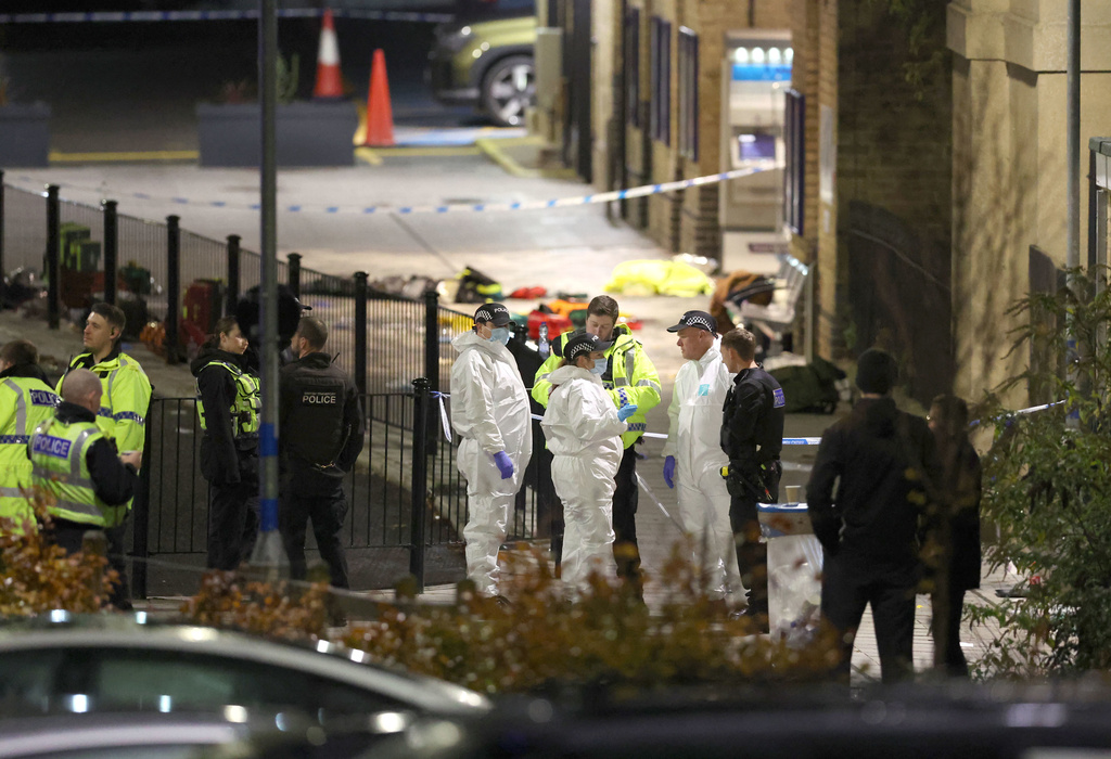 Emergency responders at Huntingdon station after a mass stabbing on a London-bound train in eastern England, in Cambridgeshire, England, Saturday, Nov. 1, 2025. (Chris Radburn/PA via AP)