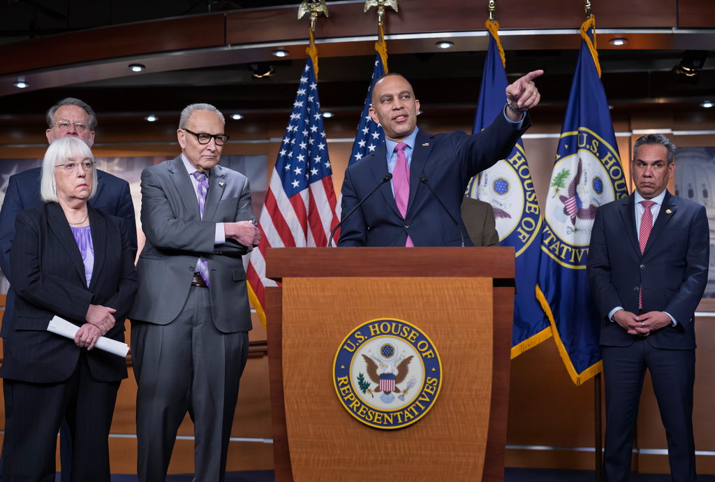House Minority Leader Hakeem Jeffries, D-N.Y., center, joined at left by Senate Minority Leader Chuck Schumer, D-N.Y., and other leaders, calls on reporters during a news conference at the Capitol in Washington, Wednesday, Feb. 4, 2026. (AP Photo/J. Scott Applewhite)