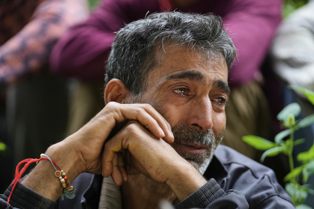 Hari Chand mourns the death of his wife during flash floods in Chositi village, in Kishtwar district, Indian-controlled Kashmir, Friday, Aug. 15, 2025. (AP Photo/Channi Anand)