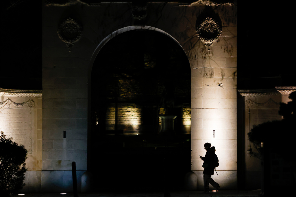 A pedestrian walks along Brown University's campus on Thayer St. in Providence, R.I., Wednesday, Dec. 17, 2025. (Lily Speredelozzi/The Sun Chronicle via AP)