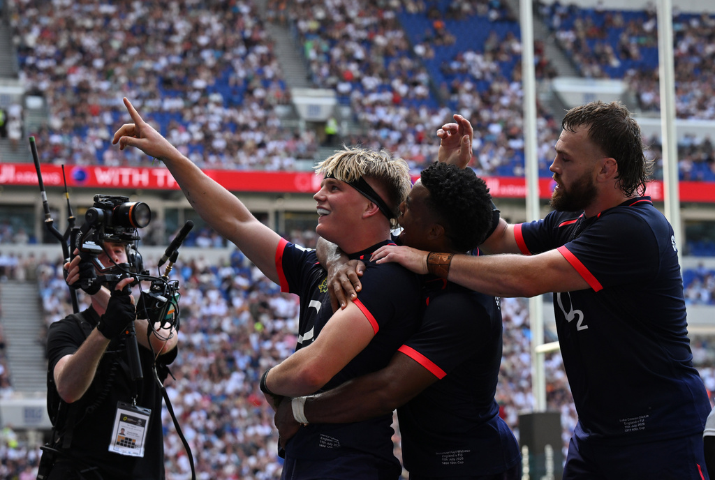 England's Henry Pollock, left, celebrates after scoring a try during the Nations Championship rugby match between England and Fiji in Liverpool, England, Saturday, July 11, 2026. (Bruce Rollinson/PA via AP)
