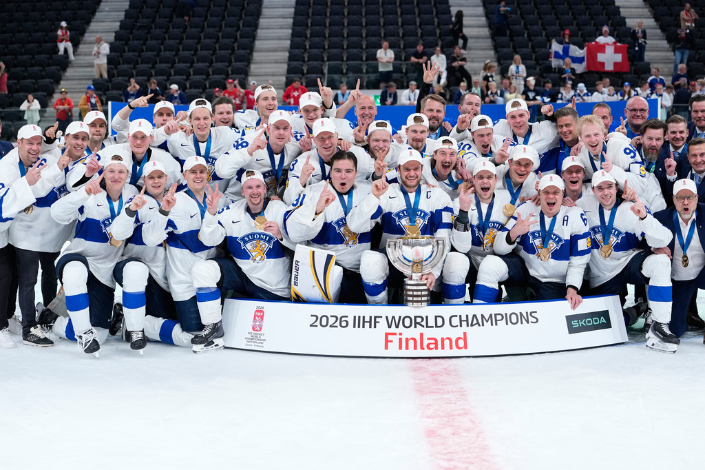 Finland players celebrate with trophy after winning the 2026 IIHF Men's Ice Hockey World Championship final match against Switzerland, in Zurich, Switzerland, Sunday, May 31, 2026. (AP Photo/Darko Bandic)