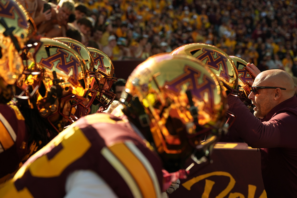 Minnesota head coach P.J. Fleck, right, hypes up his players before an NCAA college football game against Michigan, Saturday, Oct. 3, 2026, in Minneapolis. (AP Photo/Abbie Parr)