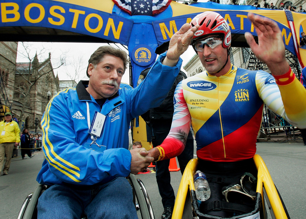 FILE - Ernst Van Dyk of South Africa, right, shakes hands with former wheelchair winner Bob Hall, after he won the mens wheelchair division of the 110th running of the Boston Marathon, Monday, April 17, 2006. (AP Photo/Elise Amendola, File)