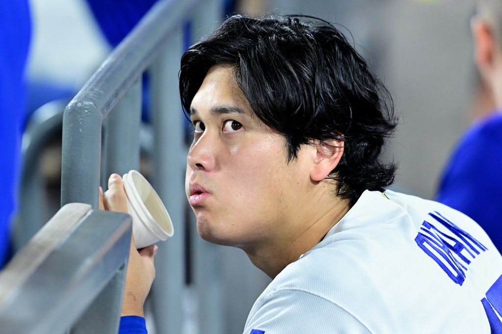 Los Angeles Dodgers Shohei Ohtani (17) watches from the dugout during the seventh inning of a baseball game against the Seattle Mariners, Tuesday, July 28 2026, in Los Angeles. (AP Photo/Wally Skalij)