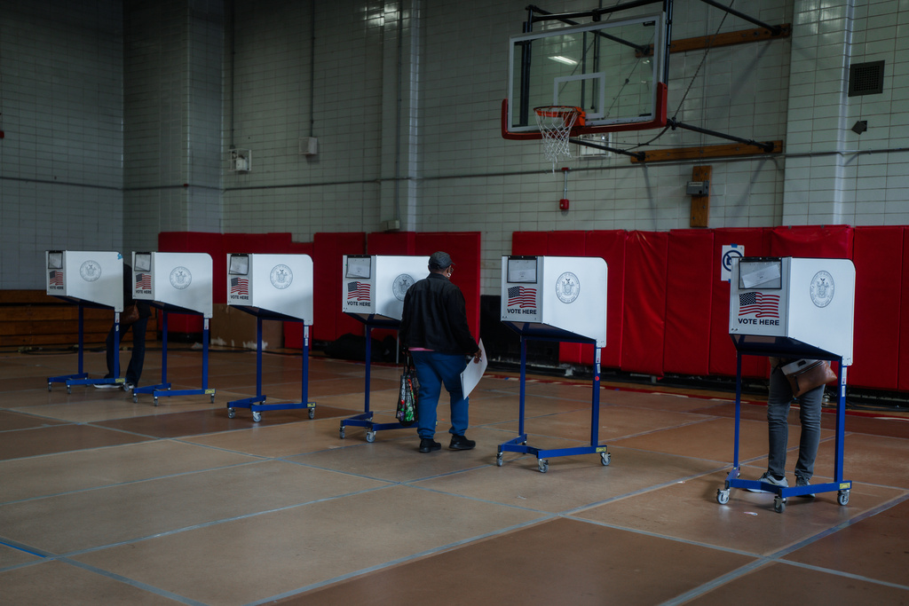 A voter carries a ballot during early voting in the New York mayoral elections on Saturday, Oct. 25, 2025, in New York. (AP Photo/Olga Fedorova)