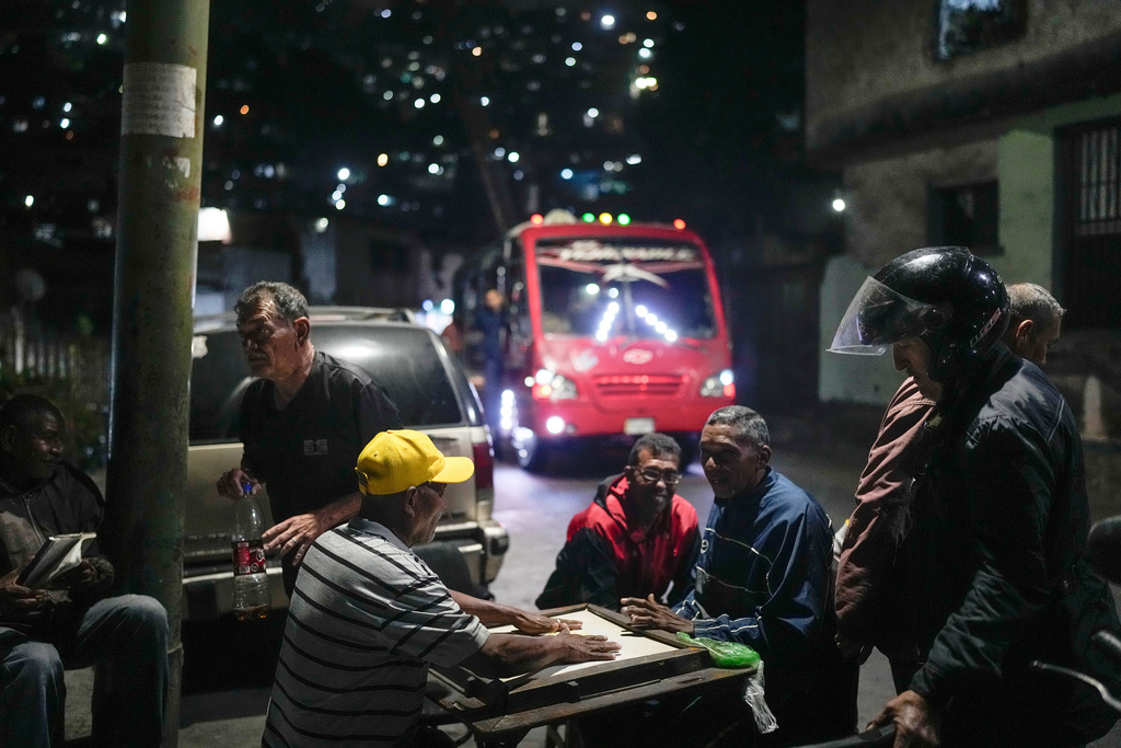 FILE - Residents play dominoes in Caracas, Venezuela, Jan. 13, 2026. (AP Photo/Matias Delacroix)