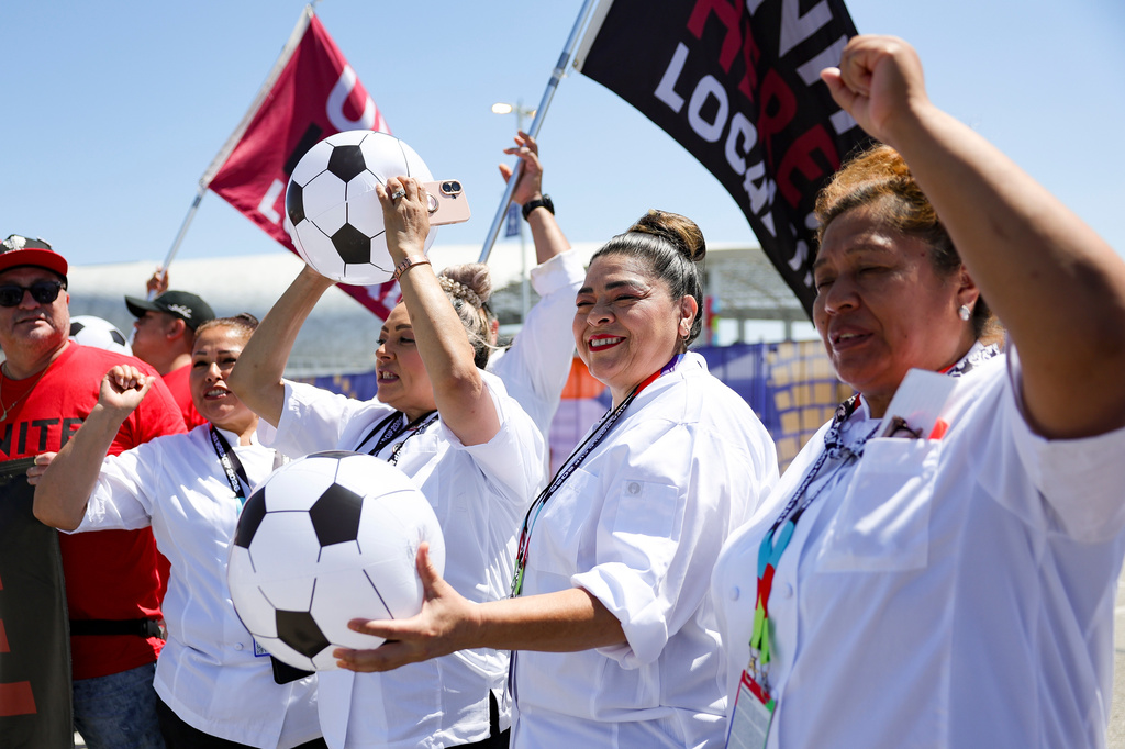 Food and beverage workers cheer during a news conference represented by UNITE HERE Local 11 in front of Sofi Stadium Tuesday, Jun. 9, 2026 in Inglewood, Calif. (AP Photo/Ryan Sun)