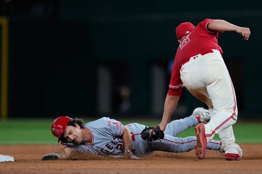 Los Angeles Angels' Adam Frazier, left, is tagged out attempting to steal second by Texas Rangers shortstop Corey Seager in the eighth inning of a baseball game Friday, Aug. 21, 2026, in Arlington, Texas. (AP Photo/Tony Gutierrez)