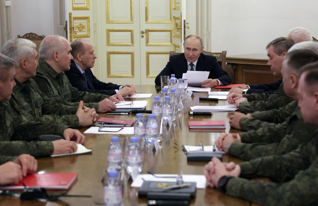 Russian President Vladimir Putin, center, speaks to the leadership of the Russian Ministry of Defense and the General Staff, commanders of troop groups in the special military operation zone in St. Petersburg, Russia, Tuesday, Oct. 7, 2025. (Mikhail Metzel, Sputnik, Kremlin Pool Photo via AP)