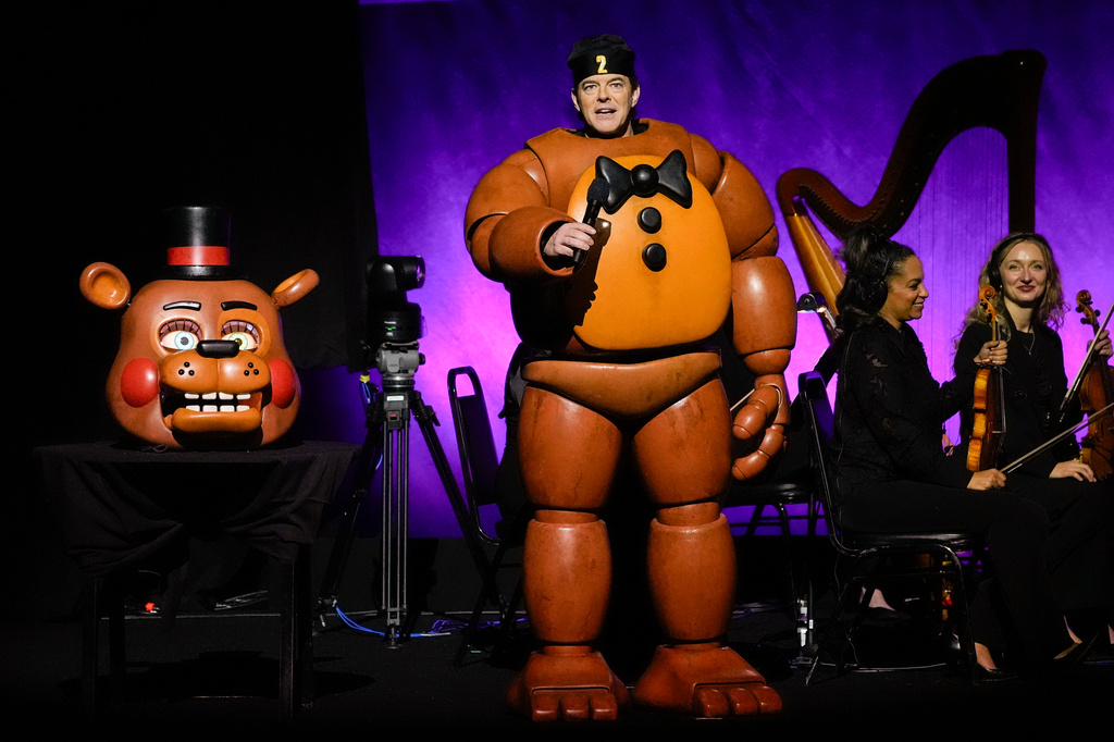 FILE - Jason Blum, CEO of Blumhouse Productions, appears onstage in a Freddy Fazbear costume, from the "Five Nights At Freddy's" franchise, during the Universal Pictures and Focus Features presentation at CinemaCon in Las Vegas on April 2, 2025. (AP Photo/Chris Pizzello, File)