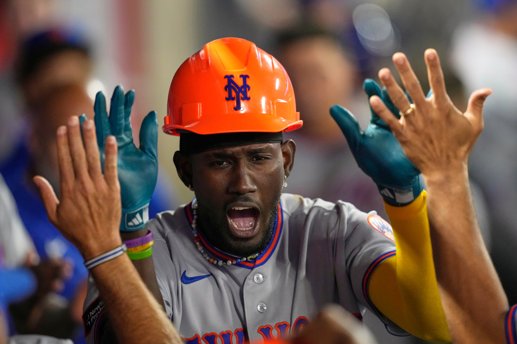 New York Mets' Ronny Mauricio is congratulated by teammates in the dugout after hitting a solo home run during the seventh inning of a baseball game against the Los Angeles Angels, Friday, May 1, 2026, in Anaheim, Calif. (AP Photo/Mark J. Terrill)
