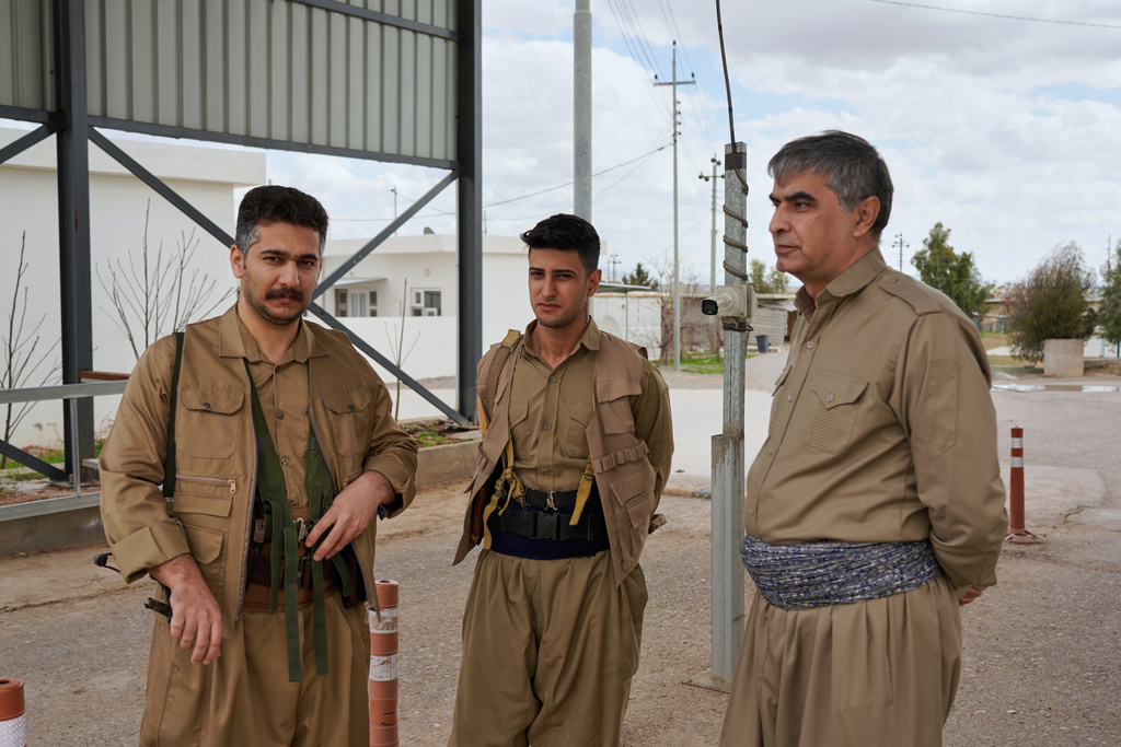 Members of the Democratic Party of Iranian Kurdistan PDKI stand at a checkpoint leading to their base in the Koya district of Irbil, Iraq, Friday, Feb. 27, 2026. (AP Photo/Rashid Yahya)