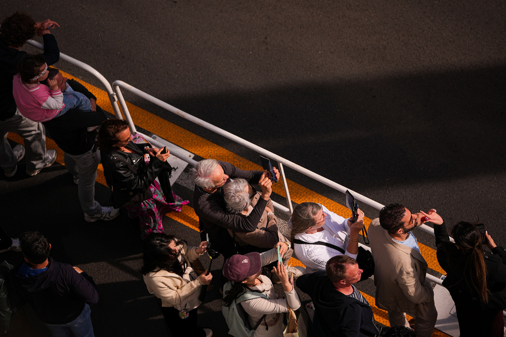 People line the street to catch a glimpse of the actors walking on red carpet during the 79th international film festival, Cannes, southern France, Thursday, May 14, 2026. (AP Photo/Andreea Alexandru)