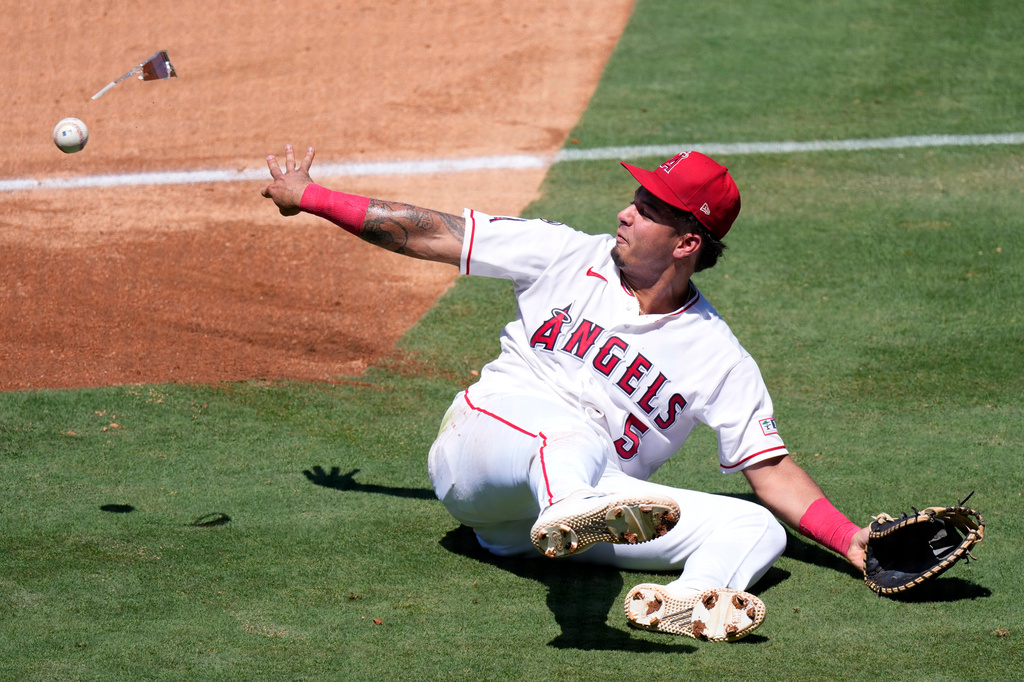 Los Angeles Angels first baseman Vaughn Grissom tosses the ball, along with his sunglasses, to first as he fails to throw out Cleveland Guardians' Travis Bazzana during the third inning of a baseball game Wednesday, Aug. 26, 2026, in Anaheim, Calif. (AP Photo/Mark J. Terrill)