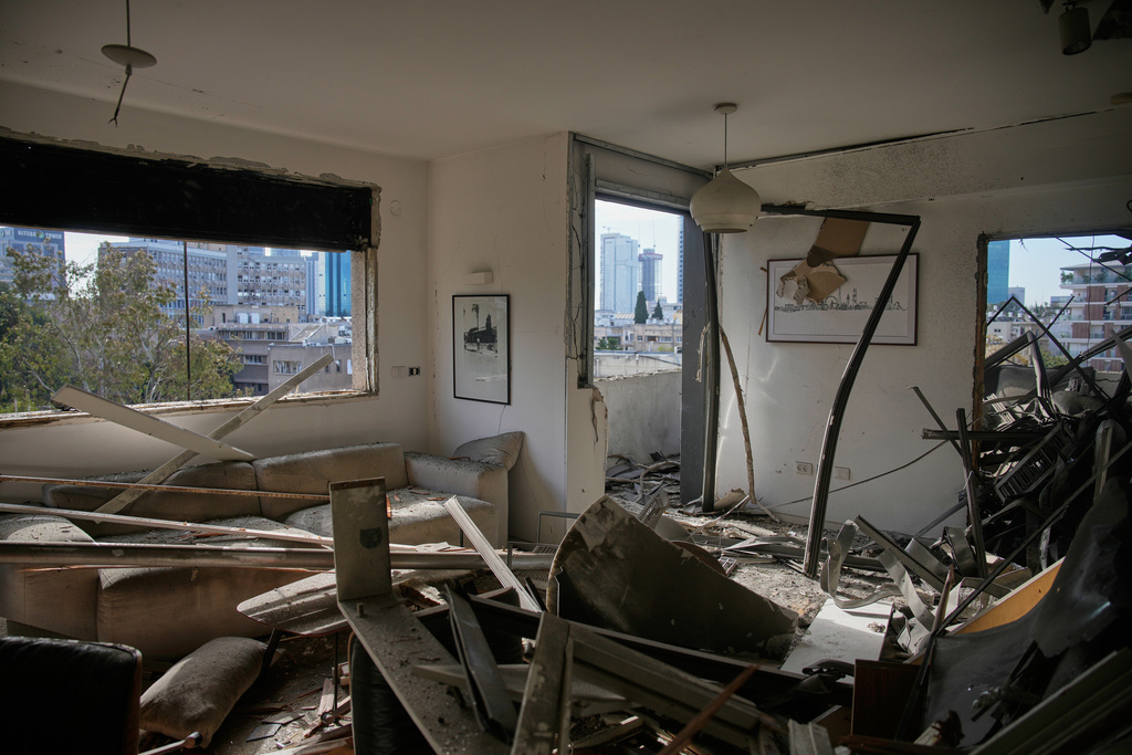 A damaged apartment is seen a day after it was struck by an Iranian missile in Tel Aviv, Israel, Sunday, March 1, 2026. (AP Photo/Ohad Zwigenberg)