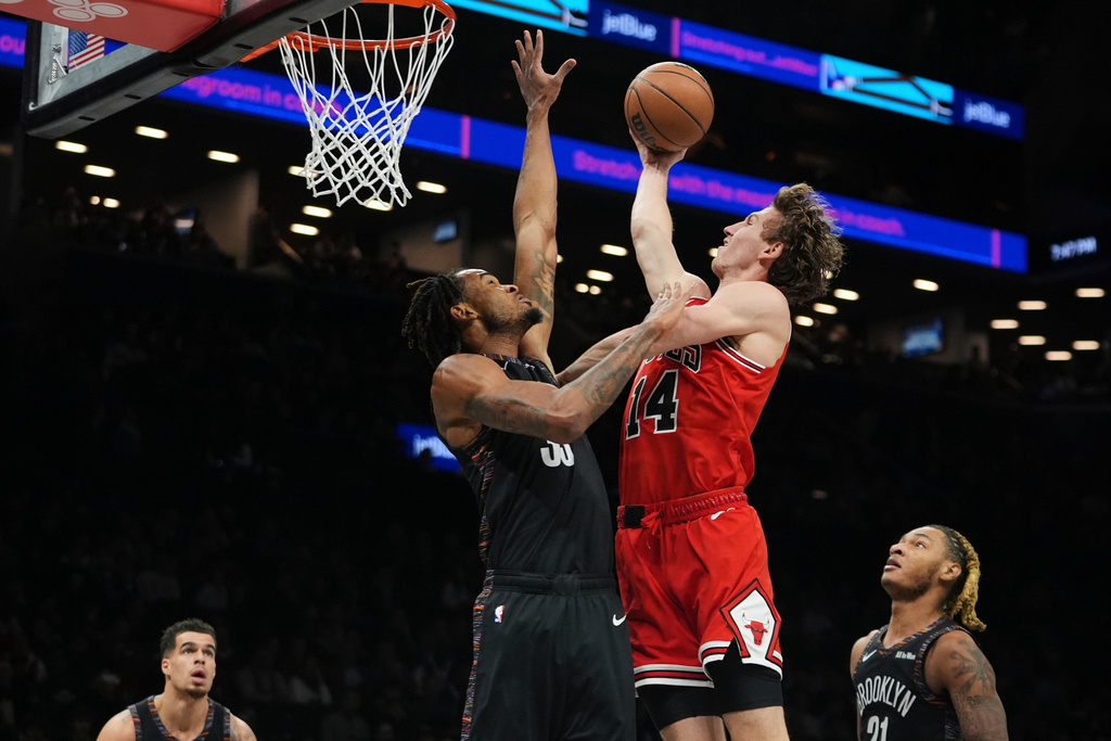 Chicago Bulls' Matas Buzelis (14) shoots over Brooklyn Nets' Nic Claxton (33) during the first half of an NBA basketball game Friday, Jan. 16, 2026, in New York. (AP Photo/Frank Franklin II)