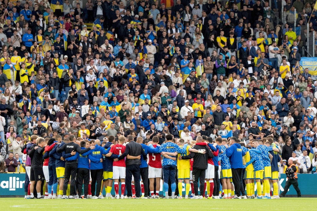 Denmark's and Ukraine's gather on the pitch after the international friendly soccer match between Denmark and Ukraine was cancelled in Odense, Denmark, Sunday, June 7, 2026, after Christian Eriksen has collapsed on the field again while playing for Denmark’s national team. (Bo Amstrup/Ritzau Scanpix via AP)