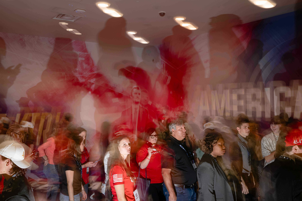 People attend Turning Point USA's AmericaFest 2025, Friday, Dec. 19, 2025, in Phoenix. (AP Photo/Jon Cherry)