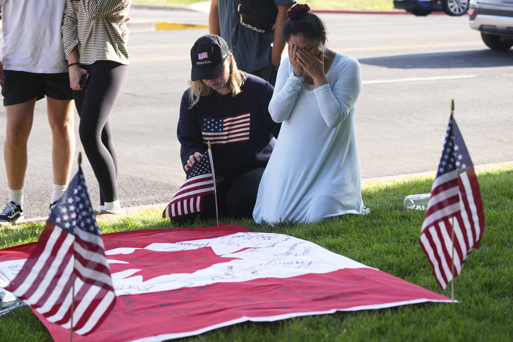 Visitors pay their respects at a memorial for Charlie Kirk at Utah Valley University on Friday, Sept. 12, 2025, in Orem, Utah. (AP Photo/Lindsey Wasson)