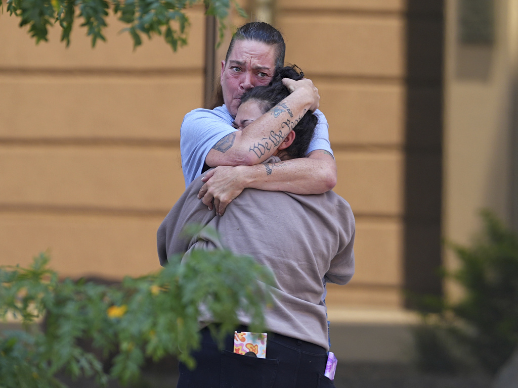Crystina Page, back, hugs a well-wisher outside the El Paso County Courthouse after a judge ruled against accepting a plea deal in the case of a funeral home owner who stored roughly 189 decomposing bodies in a building Friday, Aug. 22, 2025, in Colorado Springs, Colo. (AP Photo/David Zalubowski)