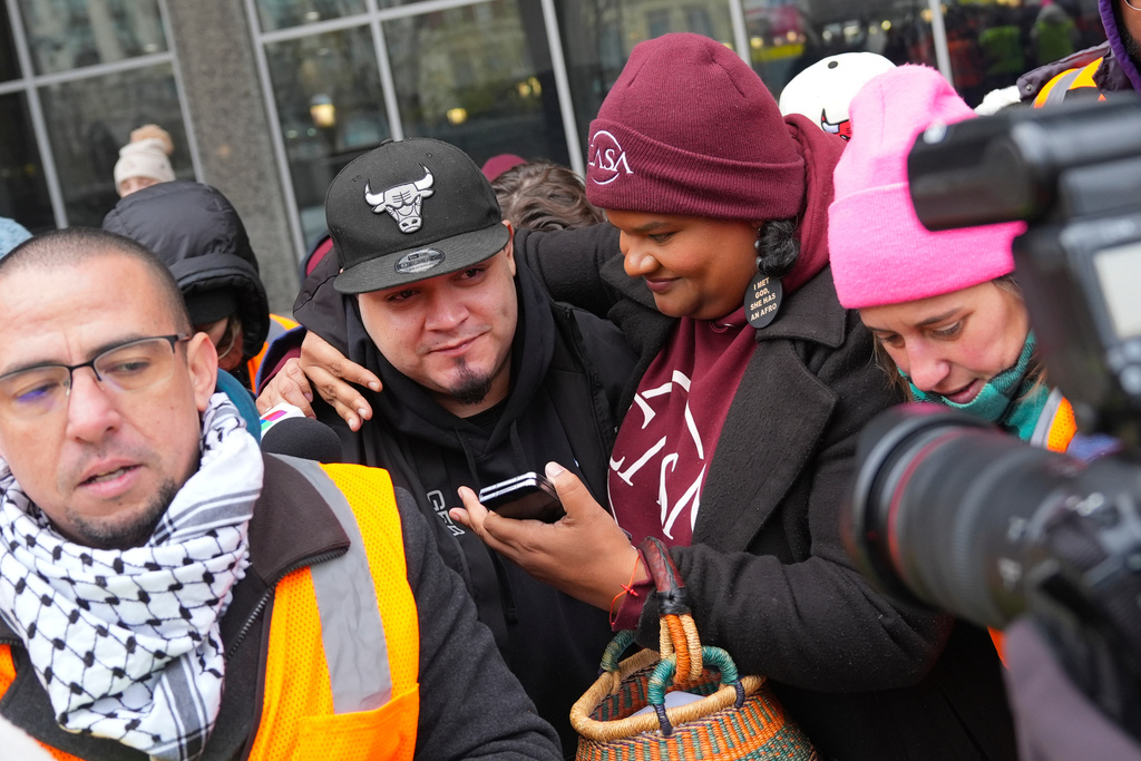 Kilmar Abrego Garcia, center, leaves with Lydia Walther-Rodriguez, right, of Casa in Maryland, after a mandatory check at the Immigration and Customs Enforcement office in Baltimore, Friday, Dec. 12, 2025, after he was released from detention on Thursday under a judge's order. (AP Photo/Stephanie Scarbrough)