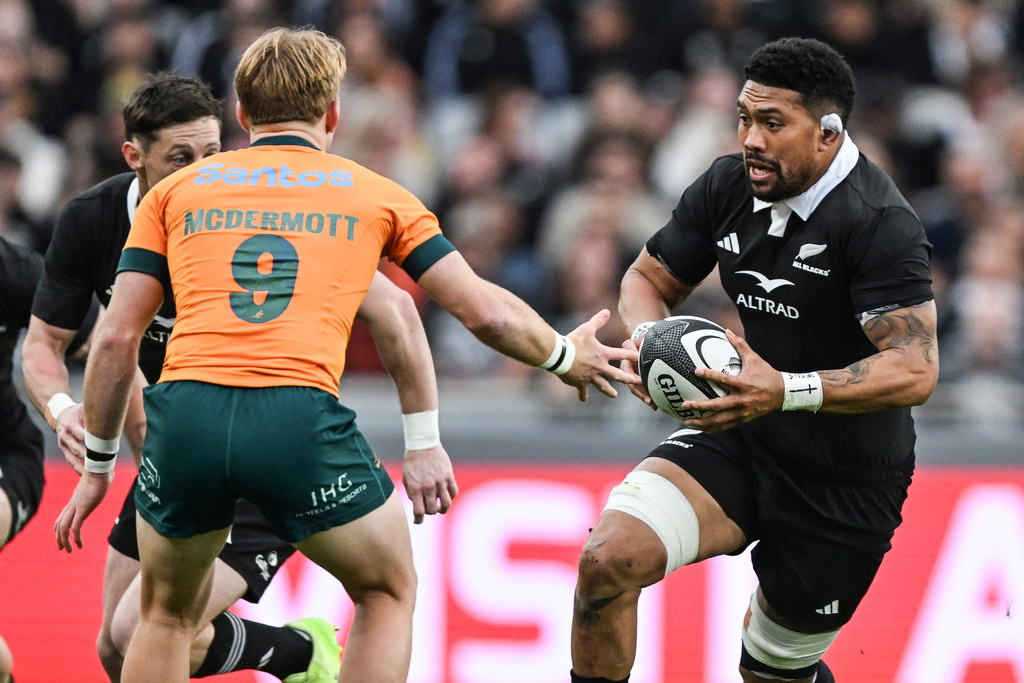 New Zealand's Ardie Savea runs at Australia's Tate McDermott during the Bledisloe Rugby test between the All Blacks and the Wallabies at Eden Park in Auckland, New Zealand, Saturday, Sept. 27, 2025. (Andrew Cornaga/Photosport via AP)